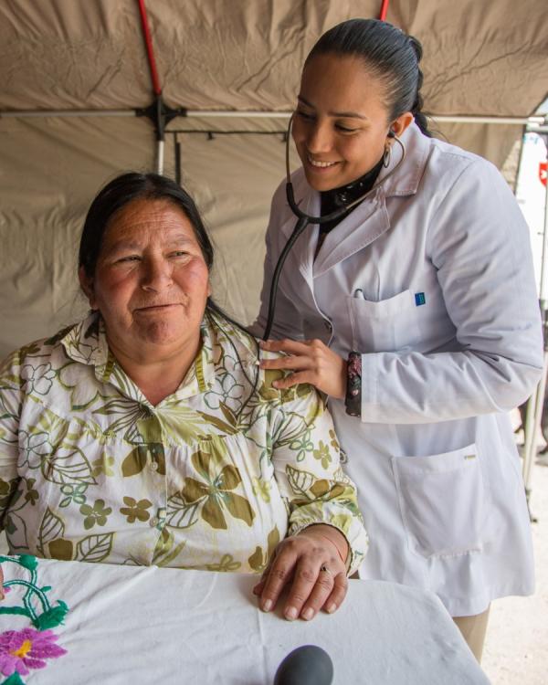 Healthcare worker caring for a woman in Mexico - Homepage - Left image Healthcare worker caring for a woman in Mexico